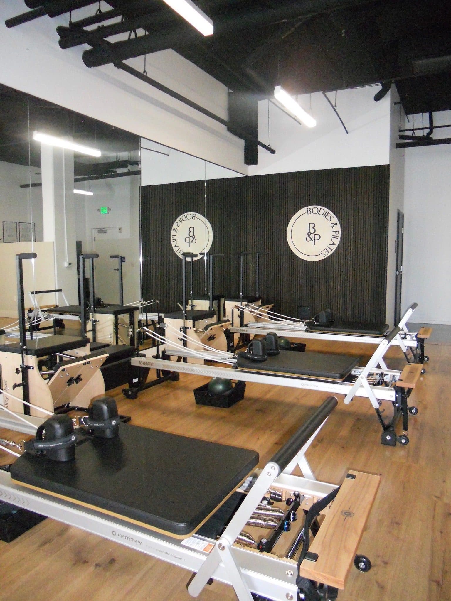 Reformer studio and the Bodies and Pilates logo wall in North Hollywood